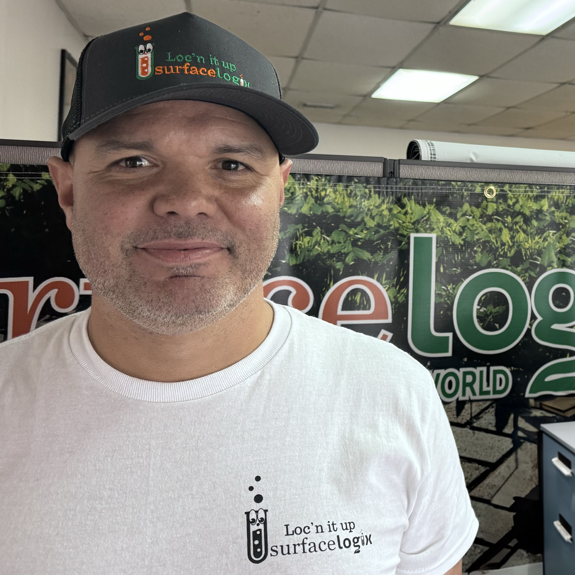 Man wearing a Surfacelogix branded cap and t-shirt